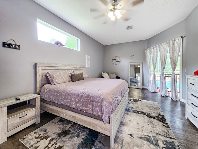 bedroom with ceiling fan, dark hardwood / wood-style flooring, and access to exterior