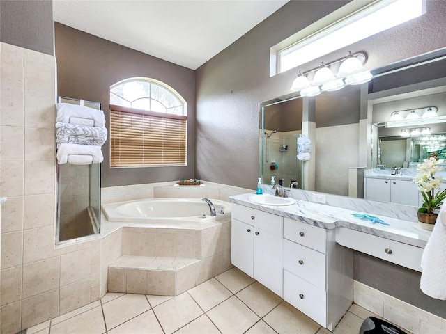 bathroom featuring tile patterned floors, independent shower and bath, and vanity