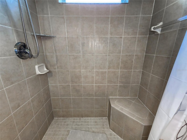 bathroom featuring a shower with curtain and a healthy amount of sunlight