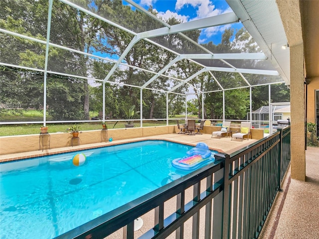 view of swimming pool featuring a patio area and a lanai