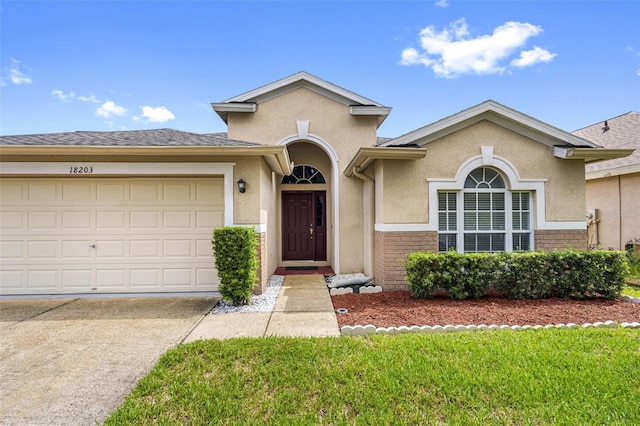 view of front of house featuring a garage and a front lawn