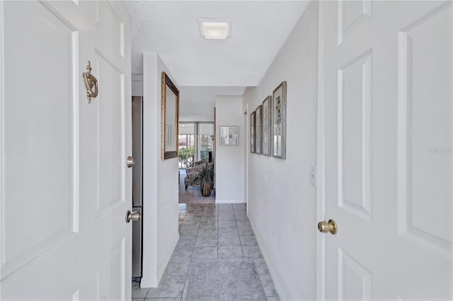 hallway featuring a textured ceiling