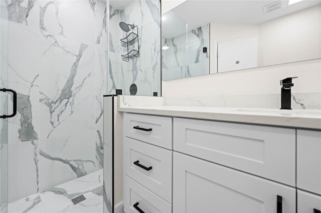 bathroom with walk in shower and vanity