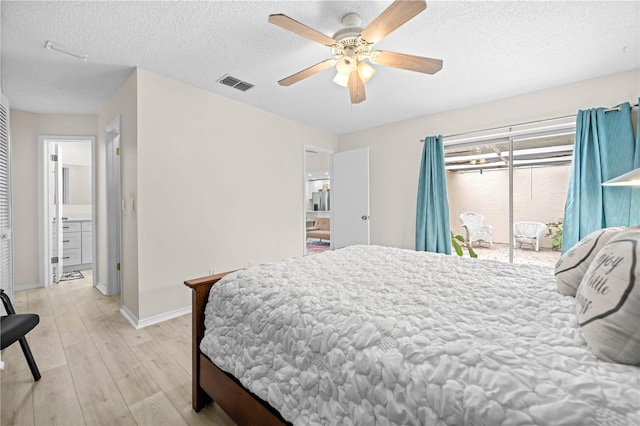 bedroom with a textured ceiling, ceiling fan, and light hardwood / wood-style flooring