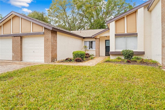 view of front of house with a garage and a front yard