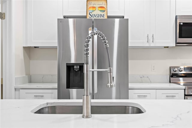 kitchen with stainless steel appliances and white cabinets