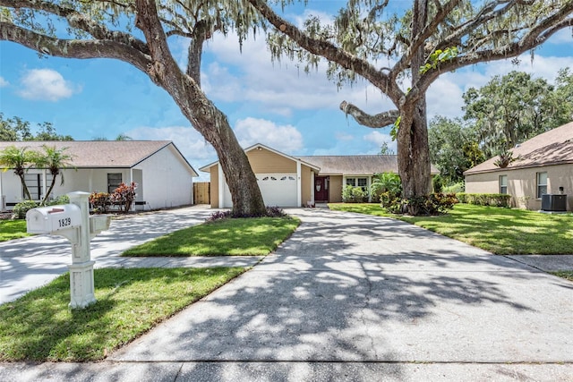 single story home featuring a garage, a front lawn, and cooling unit