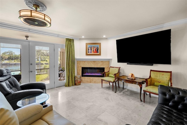 living area with french doors, recessed lighting, baseboards, a high end fireplace, and ornamental molding