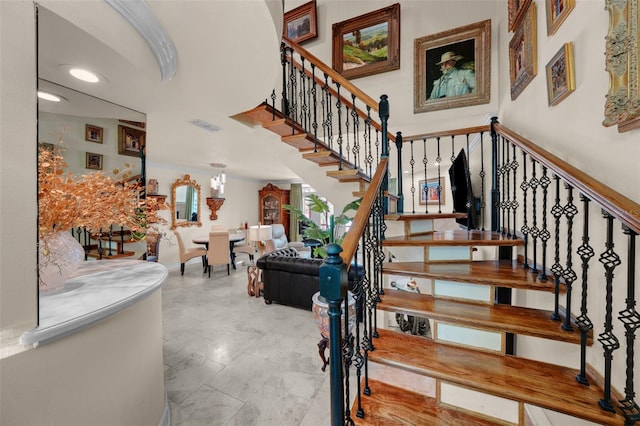 stairway featuring baseboards, recessed lighting, and visible vents