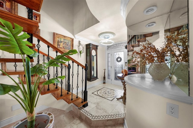 entrance foyer with baseboards and stairway