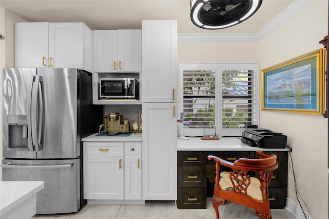 kitchen featuring white cabinets, appliances with stainless steel finishes, ornamental molding, and light countertops