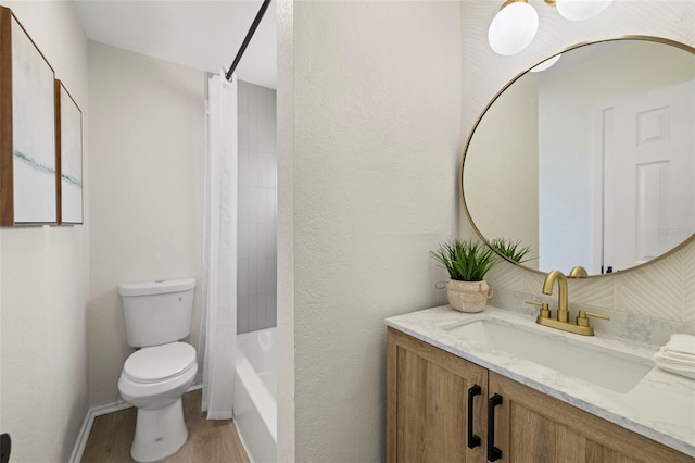 full bathroom featuring shower / bath combination, toilet, wood-type flooring, and vanity