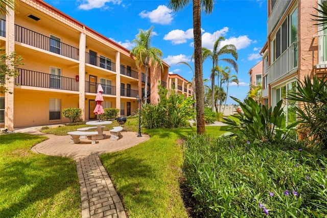 surrounding community featuring a patio area and a lawn