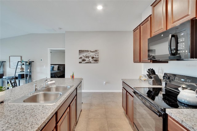 kitchen with light stone countertops, black appliances, sink, vaulted ceiling, and light tile patterned floors