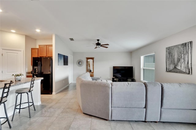 tiled living room with ceiling fan