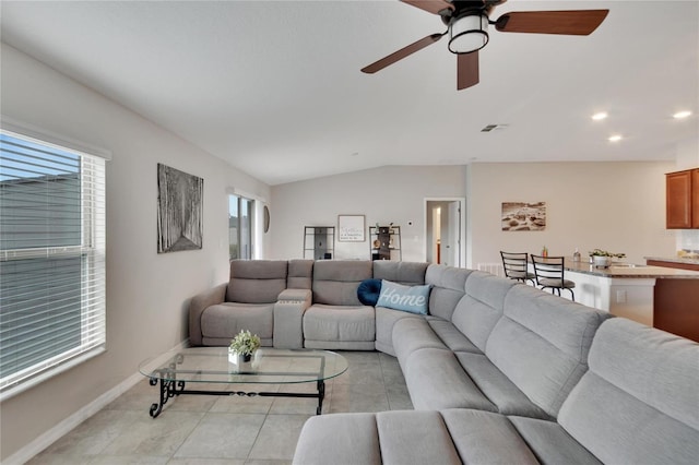 living room featuring vaulted ceiling, ceiling fan, and light tile patterned flooring