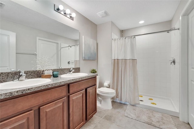 bathroom featuring a textured ceiling, toilet, vanity, curtained shower, and tile patterned flooring