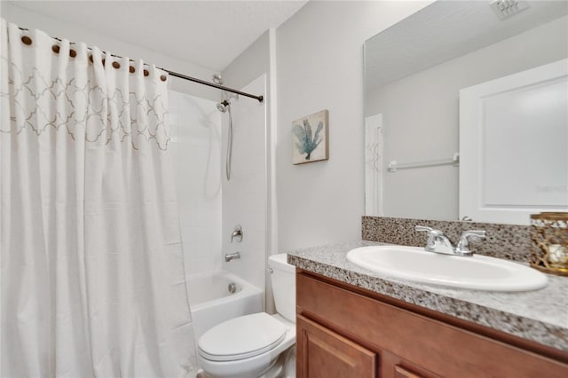 full bathroom featuring toilet, a textured ceiling, shower / bath combo with shower curtain, and vanity