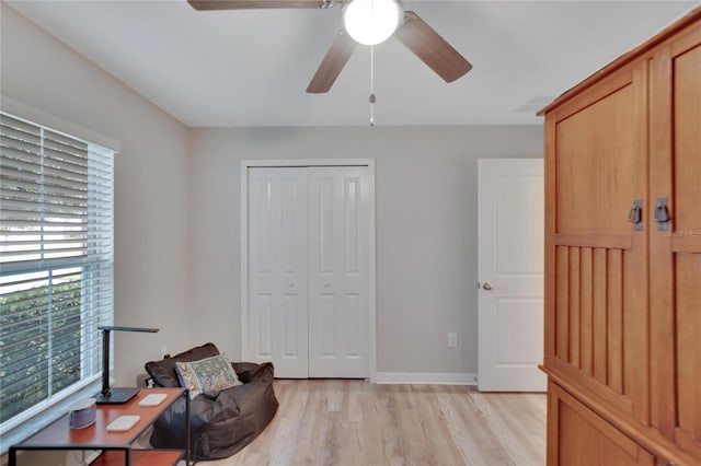 sitting room featuring light wood-type flooring and ceiling fan