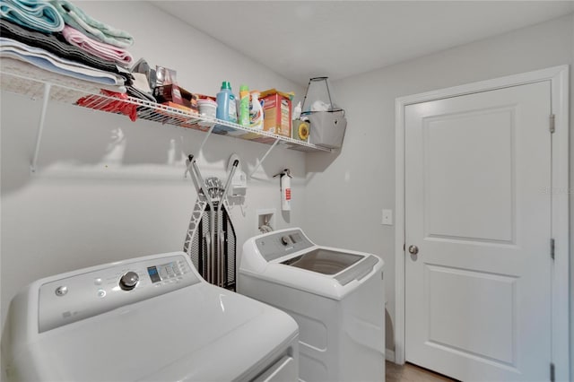 clothes washing area with washer and clothes dryer