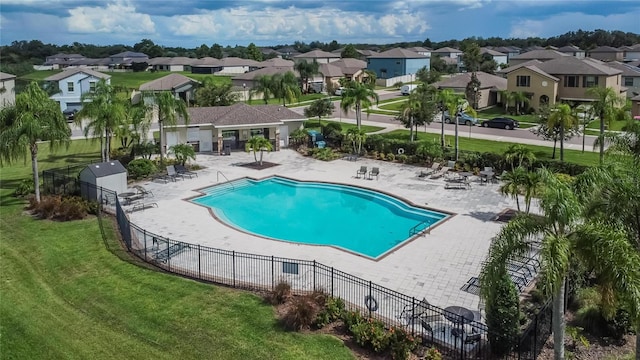 view of pool featuring a patio and a yard