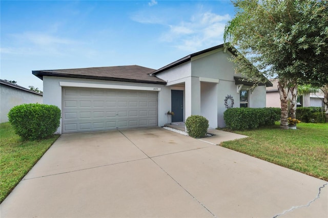 view of front of house featuring a garage and a front lawn