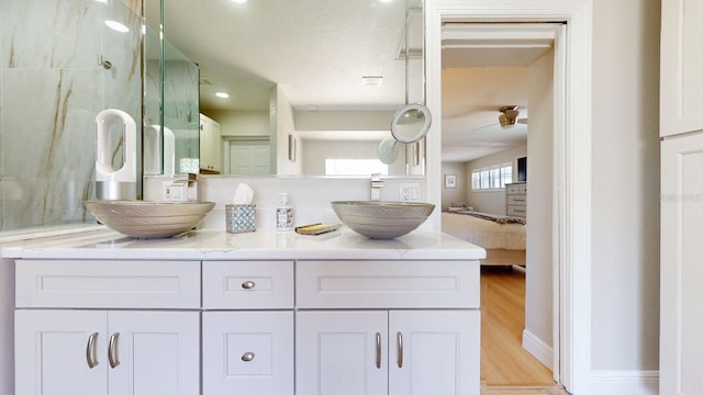 411 Harbor View Ln, Largo, FL 33770 - full bathroom featuring double vanity and wood finished floors