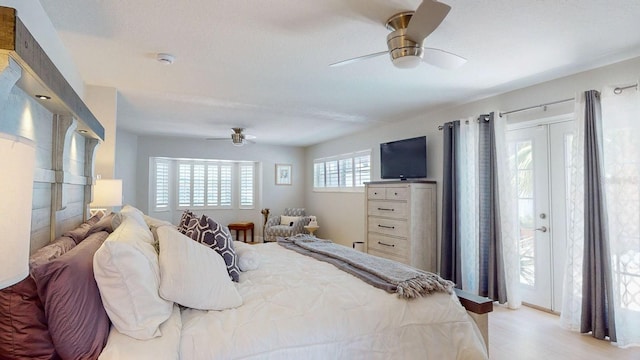 411 Harbor View Ln, Largo, FL 33770 - bedroom featuring access to outside, light wood-style flooring, and a ceiling fan