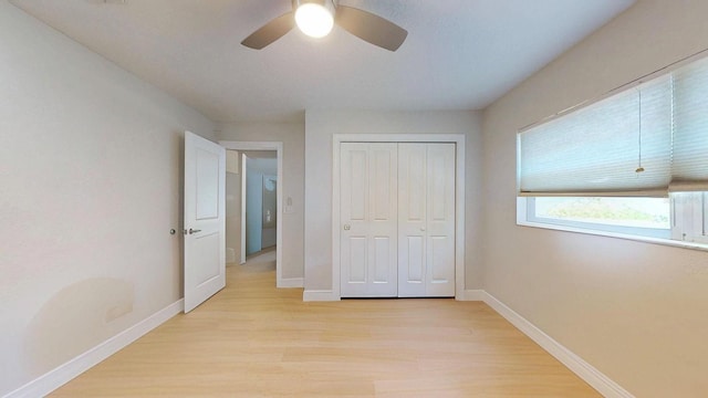 411 Harbor View Ln, Largo, FL 33770 - unfurnished bedroom featuring light wood-type flooring, baseboards, and a closet
