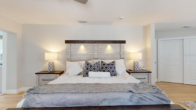 411 Harbor View Ln, Largo, FL 33770 - bedroom featuring wood finished floors, a closet, a ceiling fan, and baseboards