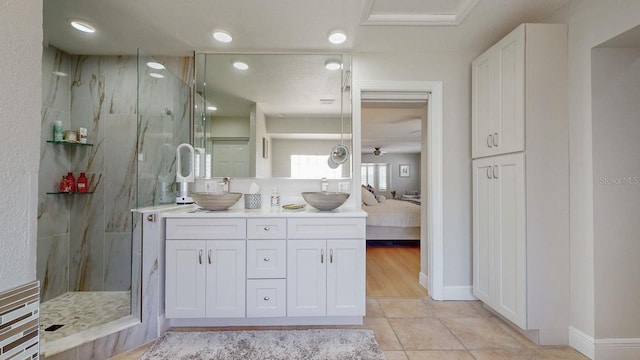 411 Harbor View Ln, Largo, FL 33770 - full bathroom with a marble finish shower, double vanity, tile patterned floors, and baseboards
