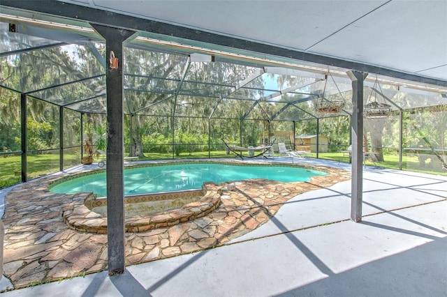 view of swimming pool featuring a lanai and a patio area