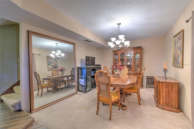 carpeted dining space featuring a textured ceiling and a chandelier