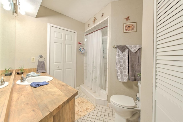 bathroom featuring vanity, walk in shower, tile patterned floors, and toilet