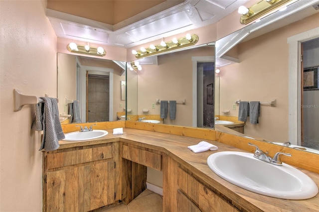 bathroom featuring tile patterned flooring and vanity