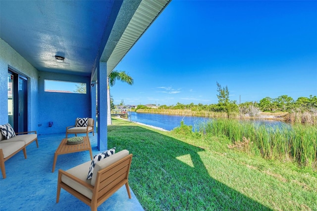 view of yard with an outdoor hangout area and a water view