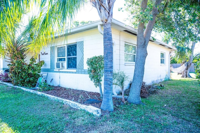 view of side of home with a yard