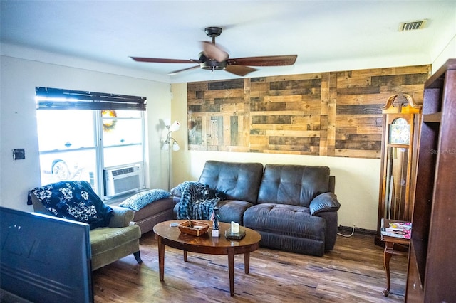 living room featuring ceiling fan, cooling unit, and hardwood / wood-style flooring