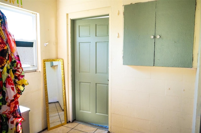 hall featuring light tile patterned floors