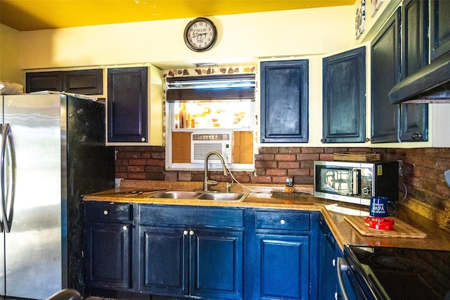 kitchen featuring tasteful backsplash, stainless steel appliances, extractor fan, blue cabinets, and sink