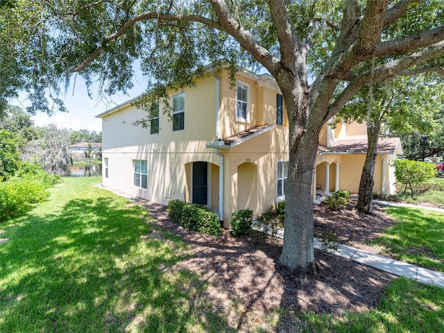 mediterranean / spanish home with a front lawn