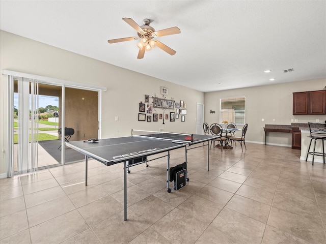 game room featuring a healthy amount of sunlight, ceiling fan, and light tile patterned floors