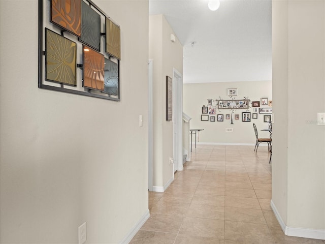 hall featuring light tile patterned flooring