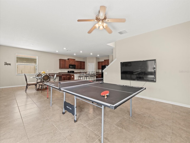 rec room with light tile patterned flooring and ceiling fan