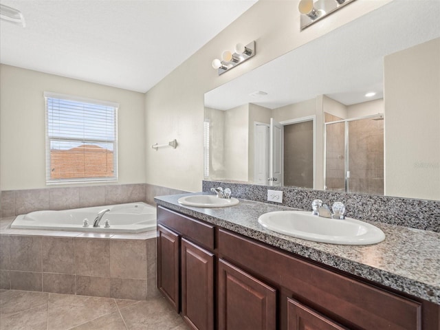 bathroom with vanity, independent shower and bath, and tile patterned flooring