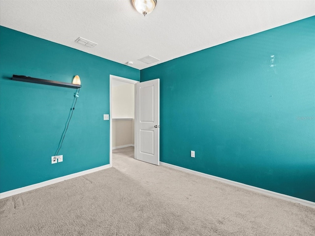 unfurnished room featuring carpet flooring