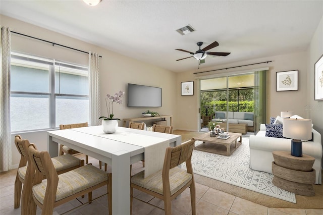 dining room with ceiling fan and light tile patterned floors