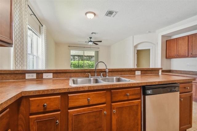 kitchen with ceiling fan, light tile patterned floors, sink, a textured ceiling, and dishwasher