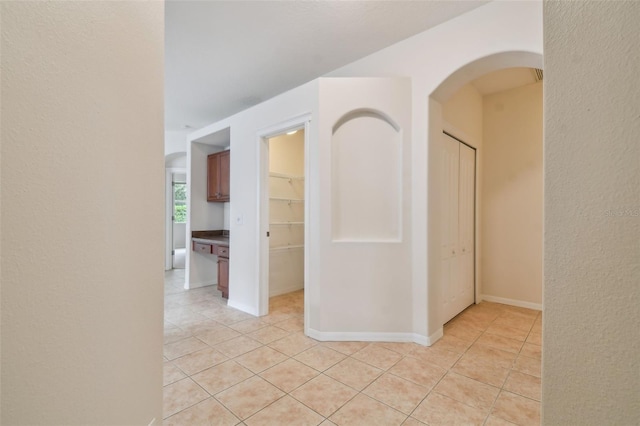 hall featuring light tile patterned floors