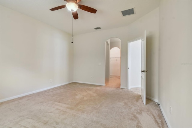 spare room with ceiling fan and light colored carpet